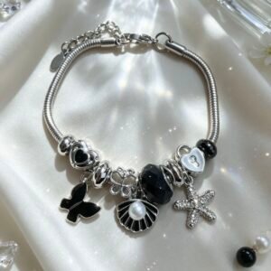 PULSERA PLATEADA CON DIJER DE CONCHA CON PERLA Y ESTRELLA DE MAR MARIPOSA NEGRA GLL-0002