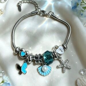 PULSERA PLATEADA CON DIJER DE CONCHA CON PERLA Y ESTRELLA DE MAR MARIPOSA AZUL GGL-0002